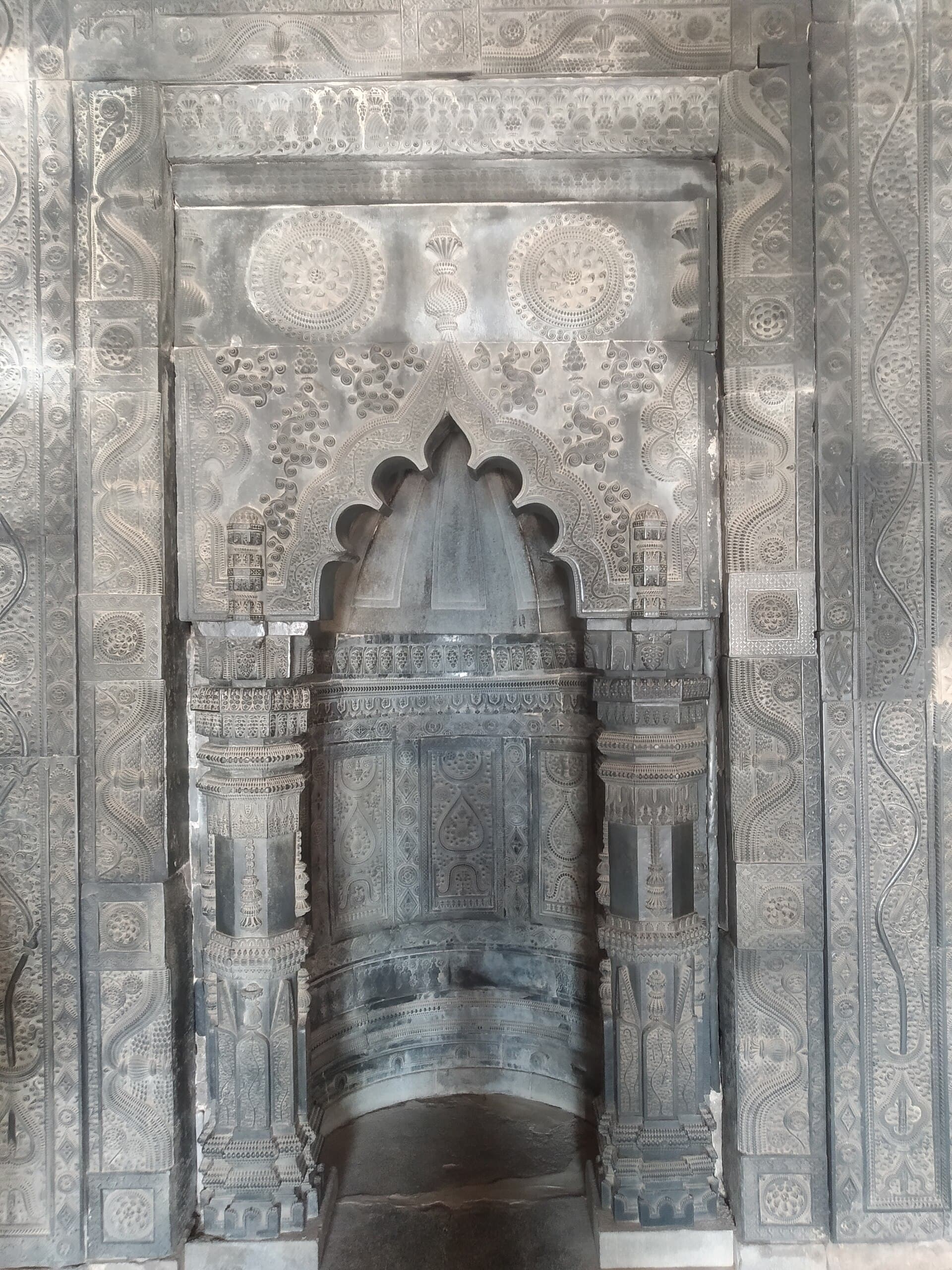 Carved stone mihrab inside Kusumba Mosque
