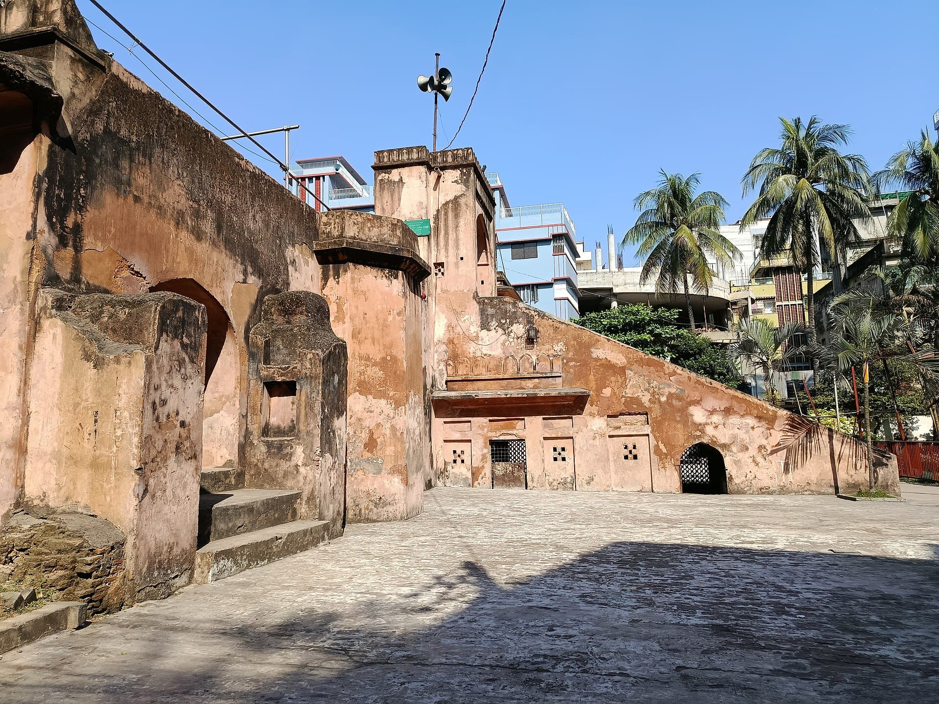 Raised brick platform and three domes of the Khan Mohammad Mridha Mosque in Old Dhaka